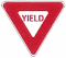yield sign: Red downward facing triangle with a white triangle inside reading "yield"